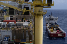 An offshore support vessel approaches the Cidade de Caraguatatuba MV27, a floating production, storage and offloading (FPSO) vessel deployed for TotalEnergies’ production activities in the Lapa Field, off the Brazilian coast near Rio de Janeiro on Oct. 25, 2025.