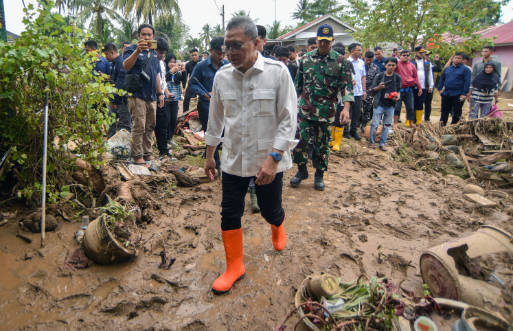 Coordinating Food Minister Zulkifli Hasan visits houses impacted by floods in Lubuk Minturun, Padang, West Sumatra on November 30, 2025.