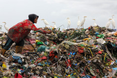 A person sifts through waste on Nov. 22  at the Terjun landfill in Medan, North Sumatra.