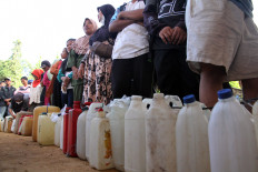 Residents line up to buy fuel on Thursday at a gas station in Pinangsori District, Central Tapanuli Regency, North Sumatra. A landslide and flash flood limited fuel supplies after road access was cut off on Nov. 25. 