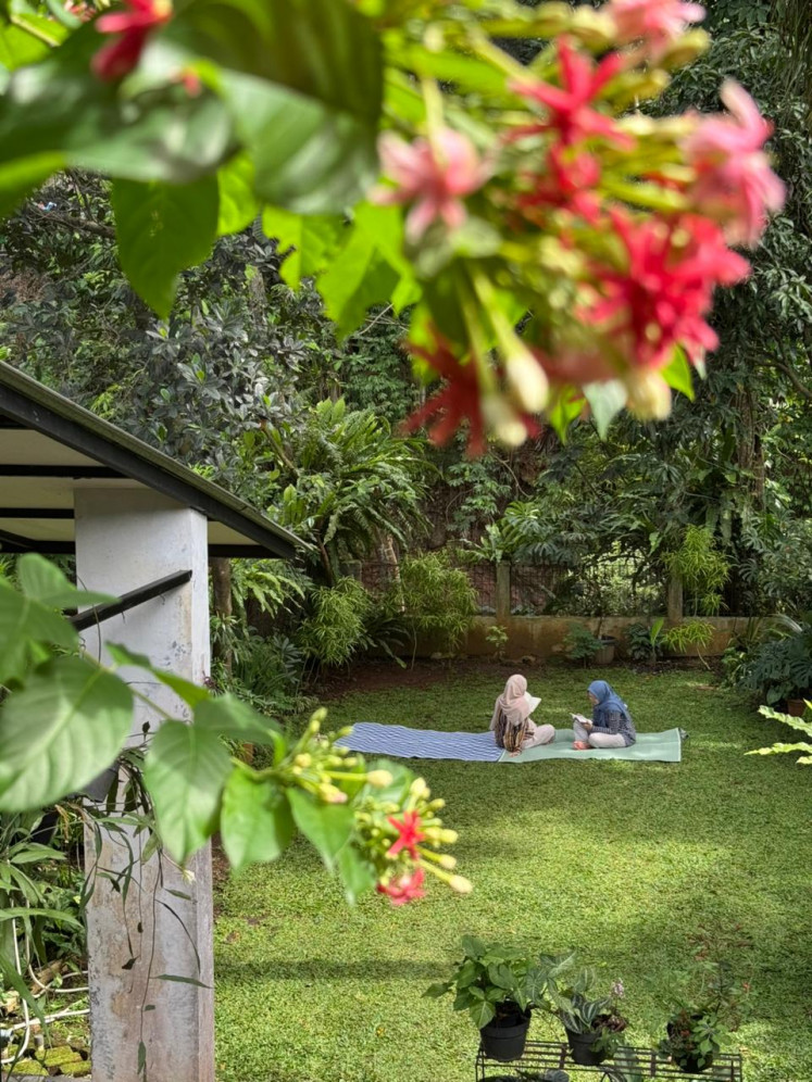Visitors enjoy books and the garden ambiance on Oct. 25, 2025 at Anjangsana Reading House during its launch in Bogor, West Java.