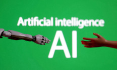 Words reading “Artificial intelligence AI“, miniature of robot and toy hand are pictured in this illustration created on Dec. 14, 2023.