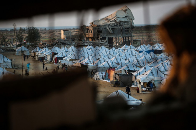Shelters are set up amid destroyed buildings at the Nuseirat camp for displaced Palestinians in the central Gaza Strip on Dec. 4, 2025. The United States, alongside Qatar and Egypt, secured a truce in Gaza that came into effect on Oct. 10 and has mostly halted two years of war between Israel and Palestinian militant group Hamas.