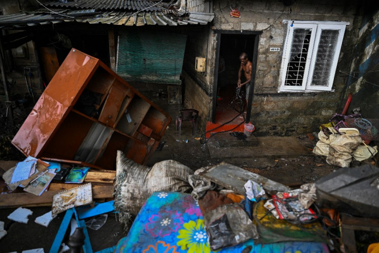 A resident clears sludge from his house following flash floods in the aftermath of Cyclone Ditwah in Wellampitiya on the outskirts of Colombo, Sri Lanka on Dec. 5, 2025. The death toll from Sri Lanka's devastating floods and landslides rose to 607 on Dec. 5 as hopes faded for another 214 still missing, the Disaster Management Centre said. 