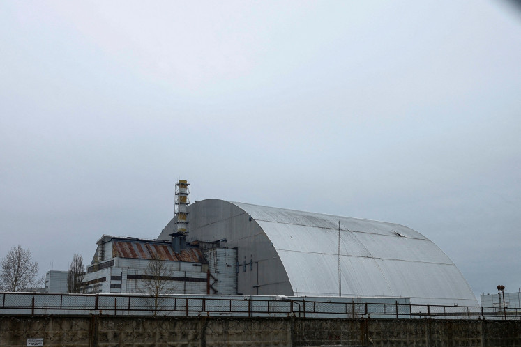 A general view shows the New Safe Confinement (NSC) structure, that covers the old sarcophagus which confines the remains of the damaged fourth reactor, and was damaged by a drone strike amid ongoing Russia's attack on Ukraine at the Chornobyl Nuclear Power Plant in Kyiv region, Ukraine, on April 12, 2025.