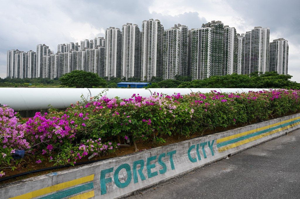 The logo of Forest City, a Malaysian development project in Johor state’s Gelang Patah launched under China's Belt and Road Initiative, marks a curb along an access road leading to a crop of towering condominiums on Sept. 1, 2023.