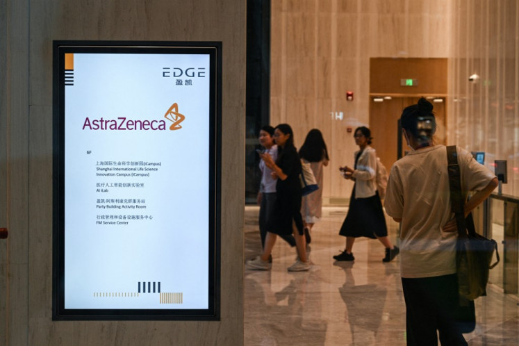 People walk in the access area of the AstraZeneca office on Sept. 5, 2024, in Shanghai, China.