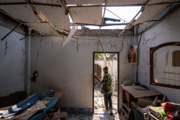 A resident shows part of a house, believed to have been damaged by Cambodian artillery shells during clashes, along the Thai-Cambodia border in Thailand's Sa Kaeo Province on December 9, 2025. The Thai army said on December 9 that Cambodian shells had fallen on two civilian homes in Sa Kaeo province, with no casualties reported.