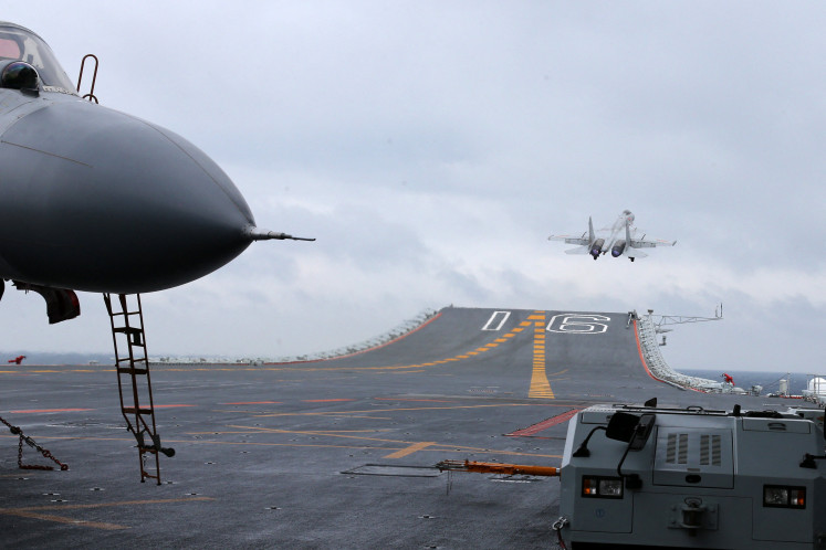 This photo taken on January 2, 2017 shows Chinese J-15 fighter jets being launched from the deck of the Liaoning aircraft carrier during military drills in the South China Sea.