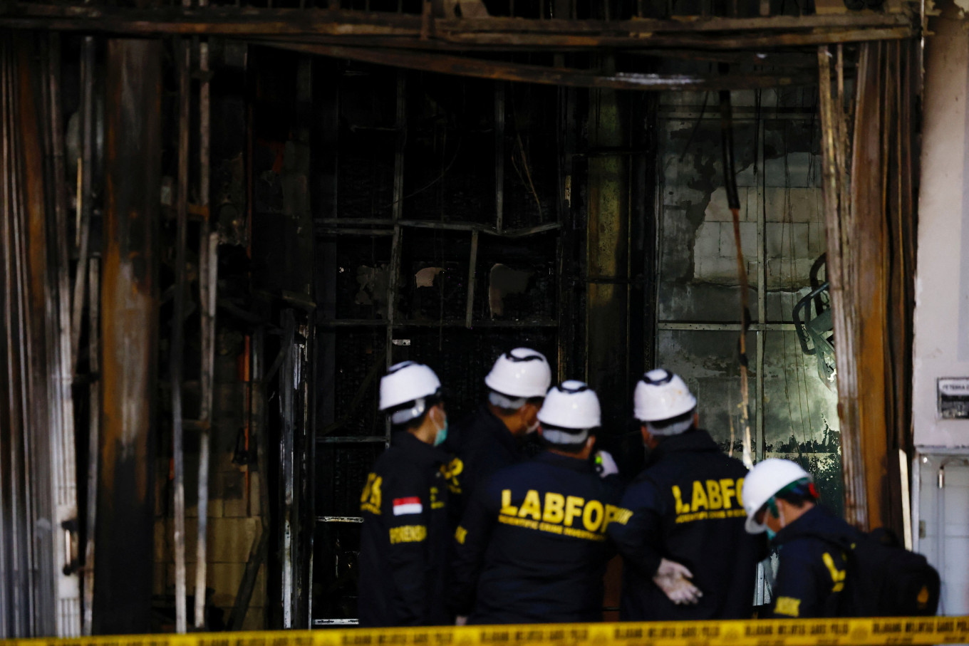 Officers from the National Police’s Forensic Laboratory (Puslabfor Bareskrim) inspect the Terra Drone Indonesia building damaged by fire, in Central Jakarta, on Dec. 9, 2025.