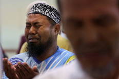 Afridoni, a local man, cries while attending funeral prayers for unidentified victims of the recent flash floods and landslides at the Great mosque of Syekh Ahmad Khatib Al-Minangkabawi in Padang, West Sumatra, December 10, 2025. 