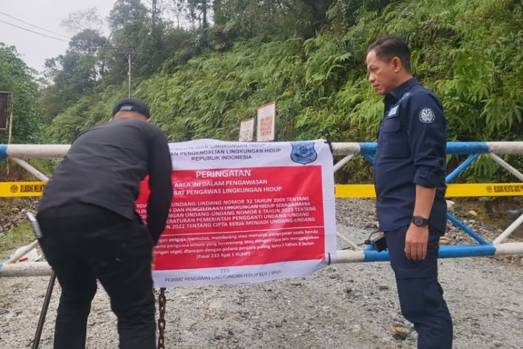Shut it down: Environment Minister Hanif Faisol Nurofiq (right) oversees the installation of a warning sign by the Environment Ministry during an inspection at a company site in the Batang Toru watershed, North Sumatra, on Dec. 5, 2025.