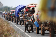 Vehicles carrying people who evacuate, amid deadly clashes between Thailand and Cambodia along a disputed border area, wait in a long line to get into a refugee camp in Chong Kal, Oddar Meanchey province, Cambodia on December 10, 2025.