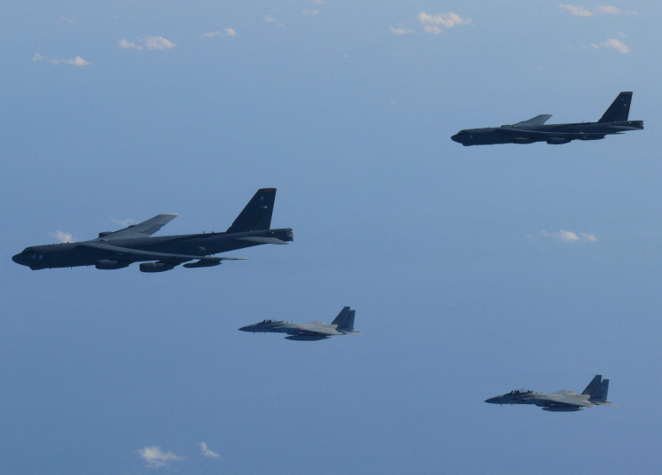 The 6th Air Wing of Japan Air Self-Defense Force's F-15 fighters hold a joint military drill with the United States B-52 bombers over Sea of Japan, in this handout picture taken by Japan Air Self-Defense Force on December 10, 2025, and released by the Joint Staff Office of the Defense Ministry of Japan on December 11, 2025. 