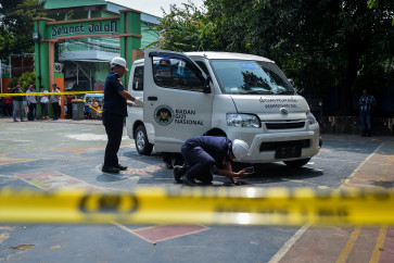 Jakarta Transportation Agency officers inspect a free-meals delivery vehicle that struck students and a teacher at SDN Kalibaru 01 Pagi state elementary school in Cilincing, North Jakarta, on Dec. 11, 2025. The incident left 20 students and a teacher injured and requiring treatment at nearby hospitals.