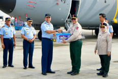 Indonesian Air Force chief of staff Air Chief Marshal M. Tonny Harjono (third left) shakes hand and delivers symbolically 27,709 kilograms disaster relief aid to National Disaster Mitigation Agency (BNPB) deputy for system and strategy Raditya Jati (third right) on Dec. 11, at Halim Perdanakusuma Air Force Base in East Jakarta. The Indonesian Air Force has sent 413,349 of disaster relief aid from Halim Perdanakusuma AFB as the main command post, as of Thursday.  