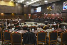 The hearing for a judicial review challenging the 2002 National Police Law is seen in session on Nov. 13, 2025, at the Constitutional Court building in Jakarta. Constitutional Court justices granted the petition and barred active police officers from holding additional government posts without retiring or resigning from the force.