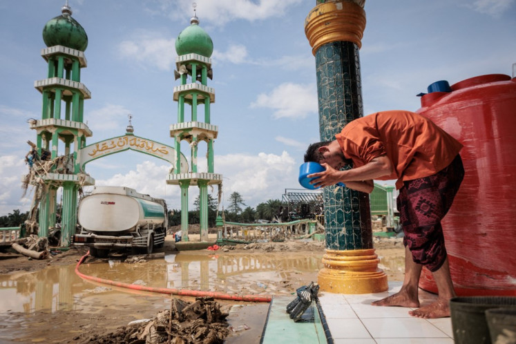 A Muslim man washes his face before attending Friday prayers at Al Ihsan Mosque, which was partially damaged by flooding, in Aceh Tamiang, Aceh on Dec. 12, 2025. Tropical storms and monsoon rains have pummelled Southeast and South Asia this month, triggering landslides and flash floods from the rainforests of Sumatra to highland plantations in Sri Lanka, with more rains are predicted.