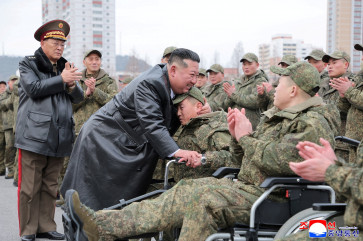 North Korean leader Kim Jong Un (third left) embraces a soldier during a welcoming ceremony at the April 25 Cultural and Tourism Center in Pyongyang, North Korea, on Dec. 12, 2025 for members of the 528th Engineer Regiment after they returned from an overseas mission.