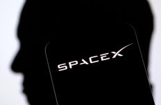 SpaceX logo and Elon Musk silhouette are seen in this illustration taken on Dec. 19, 2022.