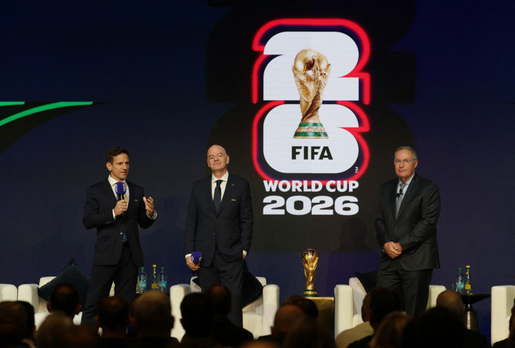 FIFA chief tournament officer Manolo Zubiria (left) speaks alongside the world soccer body&rsquo;s president Gianni Infantino (second left) and host Argentine sportscaster Andr&eacute;s Cantor on Dec. 6, 2025, during an event to announce the FIFA World Cup 2026 match schedule in Washington, D.C.