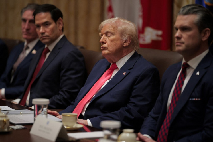 US President Donald Trump attends a meeting of his Cabinet alongside (left-right) US Interior Secretary Doug Burgum, Secretary of State Marco Rubio and Secretary of War Pete Hegseth in the Cabinet Room of the White House on December 02, 2025 in Washington, DC