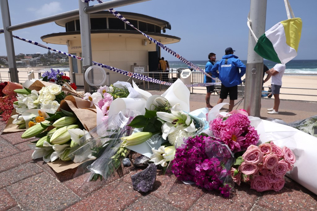 Flowers are placed outside the lifeguard tower at the Bondi Pavillion in memory of the victims of a shooting at Bondi Beach, in Sydney on December 15, 2025. A father-and-son team toting long-barreled guns shot and killed 15 people including a 10-year-old girl at Sydney's Bondi Beach on December 14, with authorities labelling it an antisemitic terrorist attack on a Jewish festival.