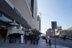 A person stands on Dec. 13, 2025, in front of Novotel Thakher Makkah Hotel, a 1,461-room hotel in Mecca, Saudi Arabia. Under the agreement, both Danantara and Takher Development acquired the hotel along with 14 land plots spanning roughly 4.4 hectares earmarked for future development.