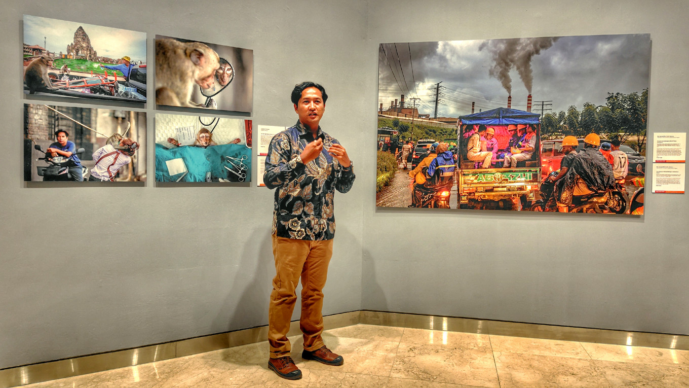 Toxic box: Indonesian photographer Mas Agung Wilis Yudha Baskoro (center) explains his work The Impact of Nickel Mining on Halmahera Island (right), which reveals the scale of air pollution and environmental damage caused by nickel mining and smelting, on Nov. 20, 225, during the opening of the 2025 World Press Photo (WPP) exhibition at Erasmus Huis in South Jakarta. The photograph won the 2025 WPP Singles category for the Southeast Asia and Oceania region.
