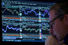 A trader works inside a booth on the floor at the New York Stock Exchange (NYSE) in New York City, US, on Nov. 19, 2025.