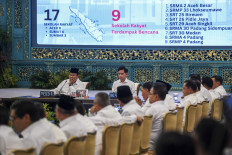 President Prabowo Subianto (left) and Vice President Gibran Rakabuming Raka (second left) listens to their ministers' explanation during a cabinet meeting at the State Palace in Jakarta on Dec. 15, 2025.