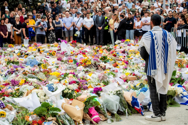 Beach in tears: A member of the Jewish community stands at a floral memorial on Dec. 16, 2025 at Bondi Beach, Sydney, Australia in honor of the victims of the mass shooting targeting a Hanukkah celebration on Dec. 14. 