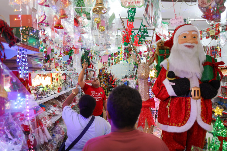 Seasonal pick-me-ups: People browse Christmas decorations on Dec. 18, 2025, at a store in Manokwari, West Papua. Sales of holiday ornaments, ranging in price between Rp 15,000 (89 US cents) and Rp 12 million, began to pick up a week ahead of Christmas this year.