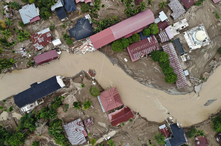 An aerial photo shows a newly formed river cutting through a residential area in Pidie Jaya, Aceh, on Dec. 18, 2025. Flash floods and the overflow of the Meureudu River on Nov. 26, 2025, caused the formation of the new waterway that split the neighborhood. 