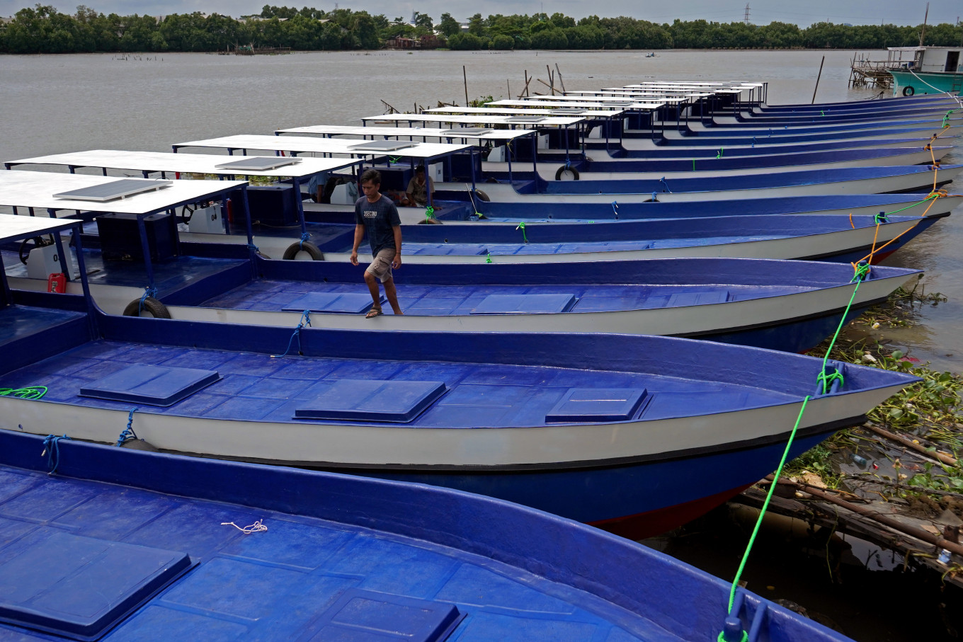 Fishing fleet: A worker walks past a row of fishing boats on Dec. 22, 2025, at the shipyard of boat maker PT Siagan Boats in Makassar, South Sulawesi. The South Sulawesi provincial administration, through its Maritime Affairs and Fisheries Agency, provided over 20 fishing boats with 5 tonnes capacity as part of efforts to boost fishing yields and fishermen&rsquo;s incomes in the province.