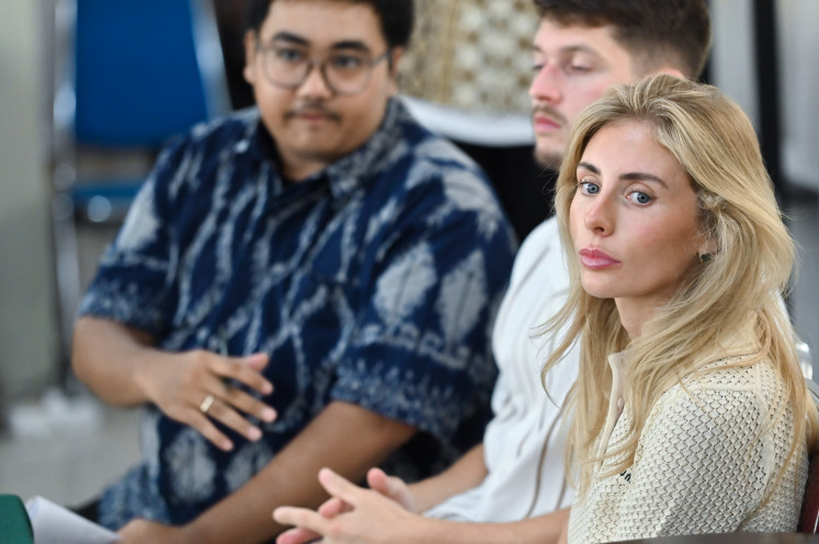 British adult film actress Tia Emma Billinger (right) attends a hearing on Dec. 12, 2025, at the Denpasar District Court in the Balinese capital. The court fined Billinger and a companion Rp 200,000 (US12) after it found the pair guilty of violating traffic regulations by using a vehicle outside its designated purpose to produce content.