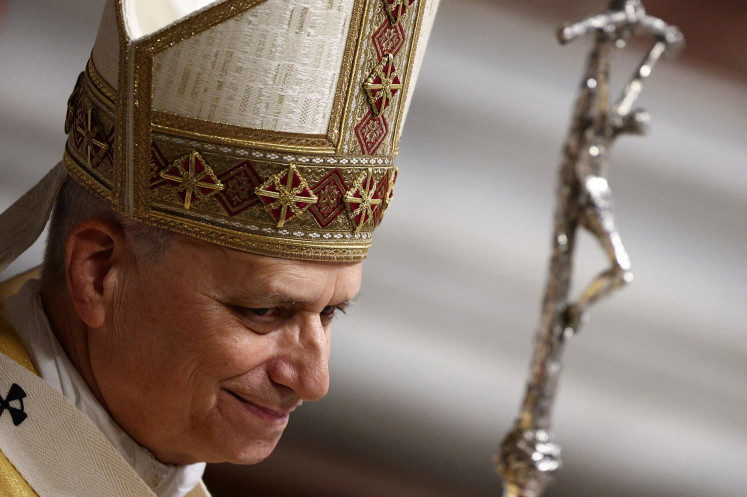 Pope Leo XIV looks on following the Christmas Eve Mass in St. Peter's Basilica at the Vatican on Dec. 24, 2025.