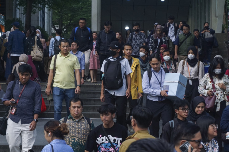 Workers congregate on Dec. 24, 2025, at the pedestrian underpass on Jl. Kendal, Central Jakarta.