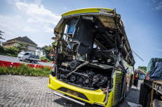 A general view of a damaged intercity bus operated by private operator Cahaya Trans on Dec. 22 at the Muktiharjo Tollgate in Semarang, Central Java. The bus was involved in a fatal road accident that killed 16 passengers and injured dozens others.