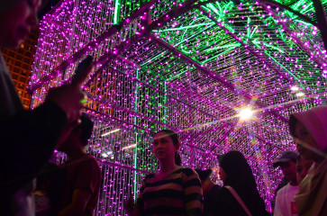 People enjoy decorative light installations during the Jakarta Light Festival 2025 on Dec. 24, 2025, at the Hotel Indonesia traffic circle in Central Jakarta. The illuminated ornaments lined major thoroughfares from Dec. 23&ndash;27 as part of celebrations for Christmas 2025 and the 2026 New Year.
