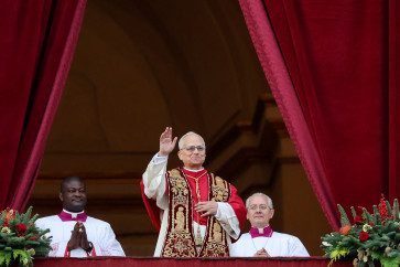 Pope Leo XIV waves as he stands on the main balcony of St. Peter's Basilica to deliver the traditional Christmas Day &ldquo;Urbi et Orbi&ldquo; speech to the city and the world at the Vatican on Dec. 25, 2025.