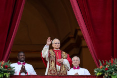 Pope Leo XIV waves as he stands on the main balcony of St. Peter's Basilica to deliver the traditional Christmas Day &ldquo;Urbi et Orbi&ldquo; speech to the city and the world at the Vatican on Dec. 25, 2025.