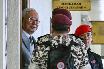 Jailed former prime minister of Malaysia Najib Razak (left) arrives for a court hearing where he seeks to land a ruling allowing him serve the rest of his six-year sentence under house arrest instead of in the Kajang Prison, at the Kuala Lumpur High Court in Kuala Lumpur, Malaysia on Dec. 22, 2025.