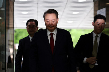 Former South Korean president Yoon Suk Yeol (center) arrives at a court to attend a hearing to review his arrest warrant requested by special prosecutors in Seoul, South Korea, on July 9, 2025.