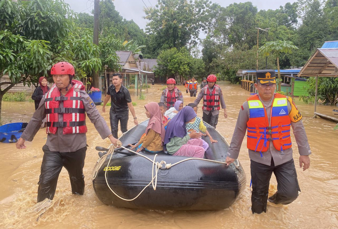 Rescuers evacuate people affected by flooding on Dec. 27 in Tebing Tinggi, Balangan, South Kalimantan.