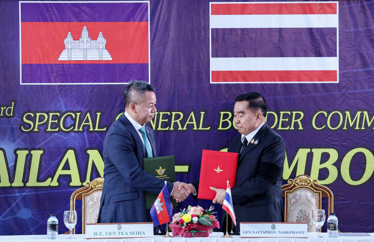 Cambodia&rsquo;s Defense Minister Tea Seiha (left) and his counterpart Thailand Defense Minister Nattaphon Narkphanit shake hands and exchange documents during a meeting in Chanthaburi province, Thailand, in this handout photo released by Agence Kampuchea Press (AKP) on Dec 27, 2025. Cambodia and Thailand agreed to an &ldquo;immediate&rdquo; ceasefire on Saturday, the two countries said in a joint statement, pledging to end weeks of deadly border clashes.