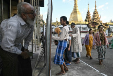 Junta gamble: People look for their name on the registry at a polling station on Dec. 28, during the first phase of Myanmar&rsquo;s general election in Yangon. Polling opened in Myanmar&rsquo;s heavily restricted junta-run elections, beginning a month-long vote democracy watchdogs describe as a rebranding of military rule.