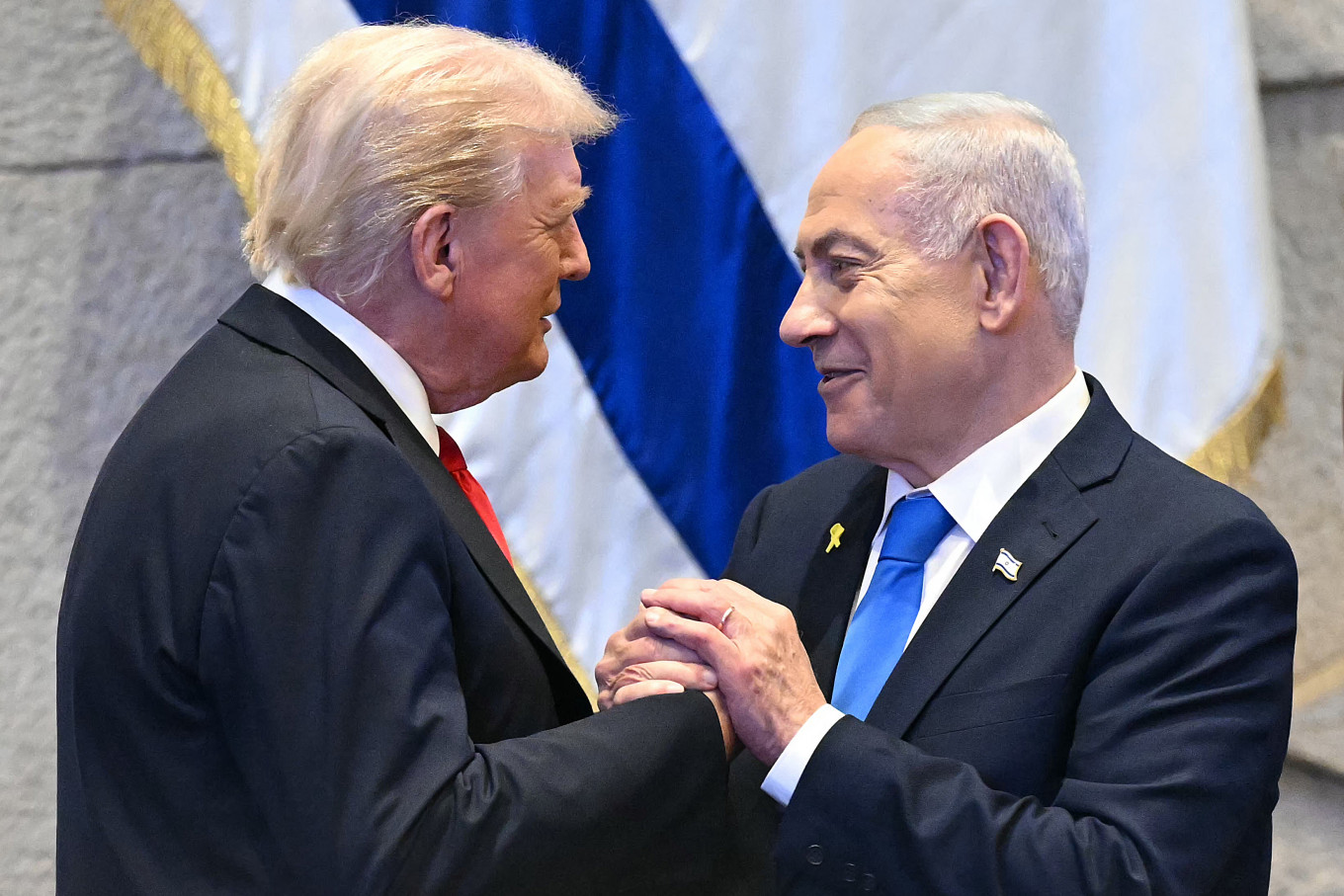 Unshaken alliance: United States President Donald Trump (left) holds hands and speaks with Israeli Prime Minister Benjamin Netanyahu on Oct. 13, 2025, at the Israeli parliament, the Knesset, in Jerusalem.