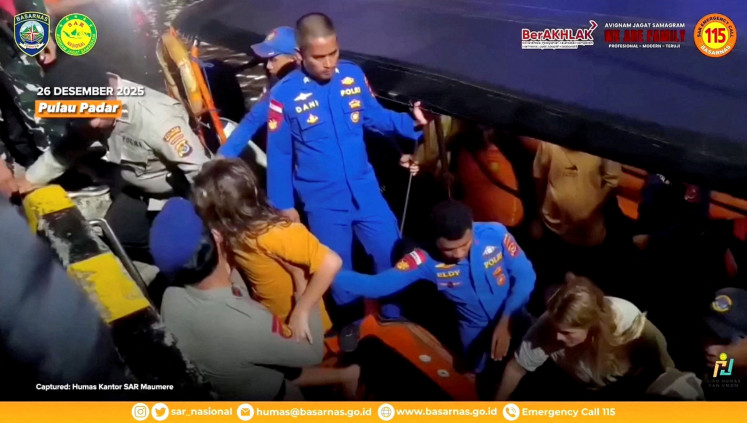 Rescue teams help to depart the rescued, as the National Search and Rescue Agency (Basarnas) said, after a boat carrying several people sank off the coast of Labuan Bajo in extreme weather, Spanish authorities and an Indonesian news agency said, in this screengrab from the video obtained by Reuters on Dec. 27, 2025.