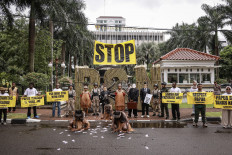 Environmental activists with Greenpeace Indonesia and members of Papuan indigenous communities hold a rally in front of the Office of the Coordinating Economy Minister in Jakarta on Dec. 18, 2025, protesting the national strategic project (PSN) to open a sugarcane plantation in Merauke that they said could cause massive deforestation in Indonesia's easternmost region.